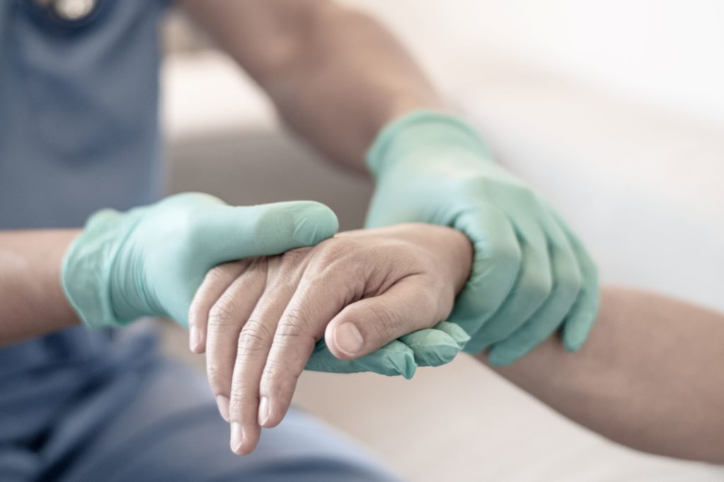 Surgical arthritis treatment recovery time and results depend on a variety of factors, including the type of hand surgery that was performed. In this image, a doctor examines a patient's hand.