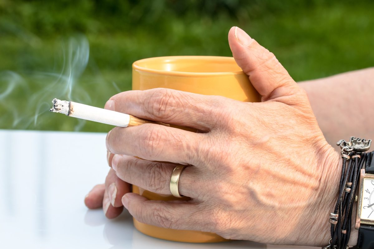 Smoking affects your hands in numerous ways, including premature aging of the skin on your hands and a slower ability to heal after cuts. This is an image of a smoker's hands with a lit cigarette.